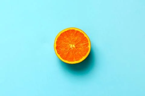 Orange half fruit sliced isolate on blue background 스톡 사진