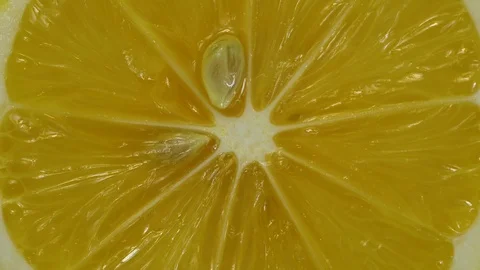 Orange half lemon spins closeup Stock Footage 121115020