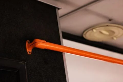 Orange handrail in the bus close up Stock Photos