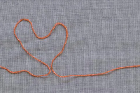 Orange heart made of threads. Stock Photos