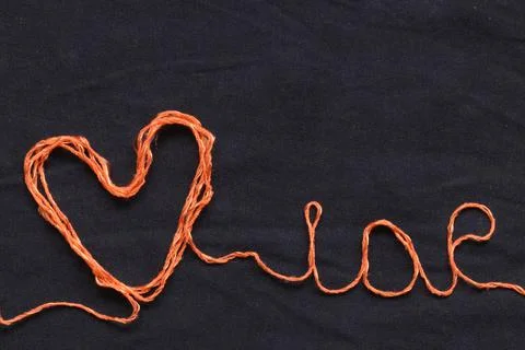 Orange heart made of threads. Stock Photos
