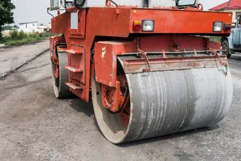 Orange Heavy Vibration roller compactor at asphalt pavement works for road Stock Photos