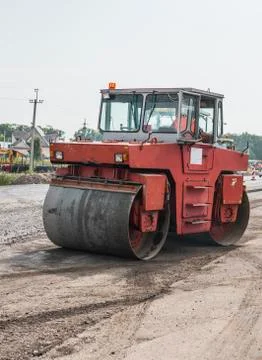 Orange Heavy Vibration roller compactor at asphalt pavement works for road Stock Photos