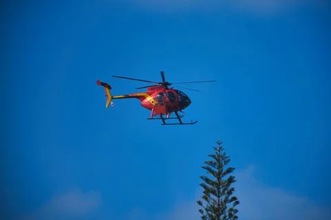 Orange Helicopter in Flight Stock Photos