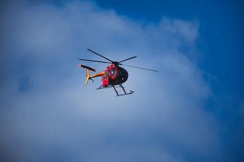 Orange Helicopter in Flight 写真素材