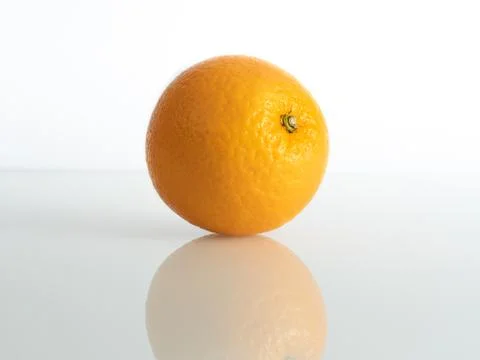 An orange inch on a white background in reflection of the base Stock Photos