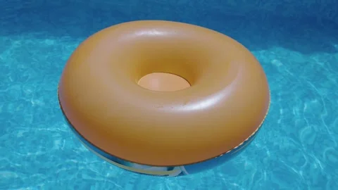 Orange inflatable ring floating on clear water in swimming pool Video stock 344102103