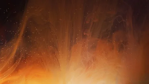 Orange ink diffusing in water Stock Footage 100021092