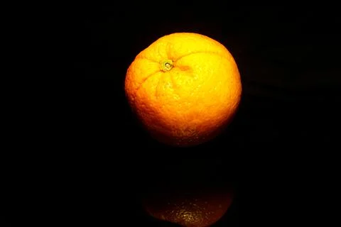 Orange isolate on black with reflection Stock Photos