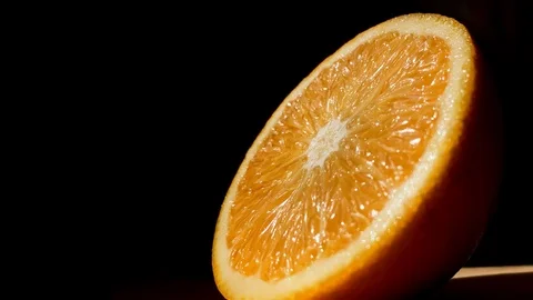 Orange isolated on a black background. Citrus fruit. Fresh and Ripe halved orang Stock Footage 115100543