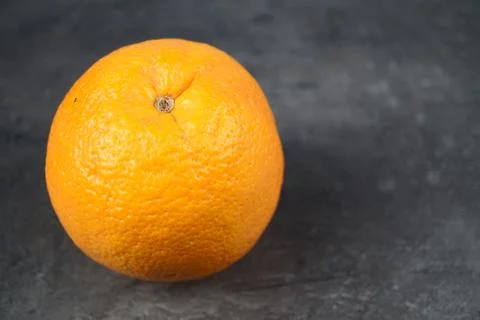 Orange isolated on dark background. Close-up photo Stock Photos