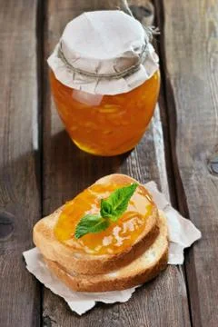 Orange jam on bread Stock Photos