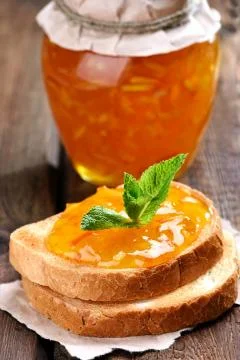 Orange jam on bread Stock Photos