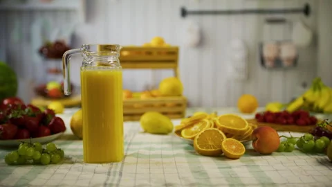 Orange juice and fresh fruit on kitchen counter - medium, tracking shot Stock Footage 341027596