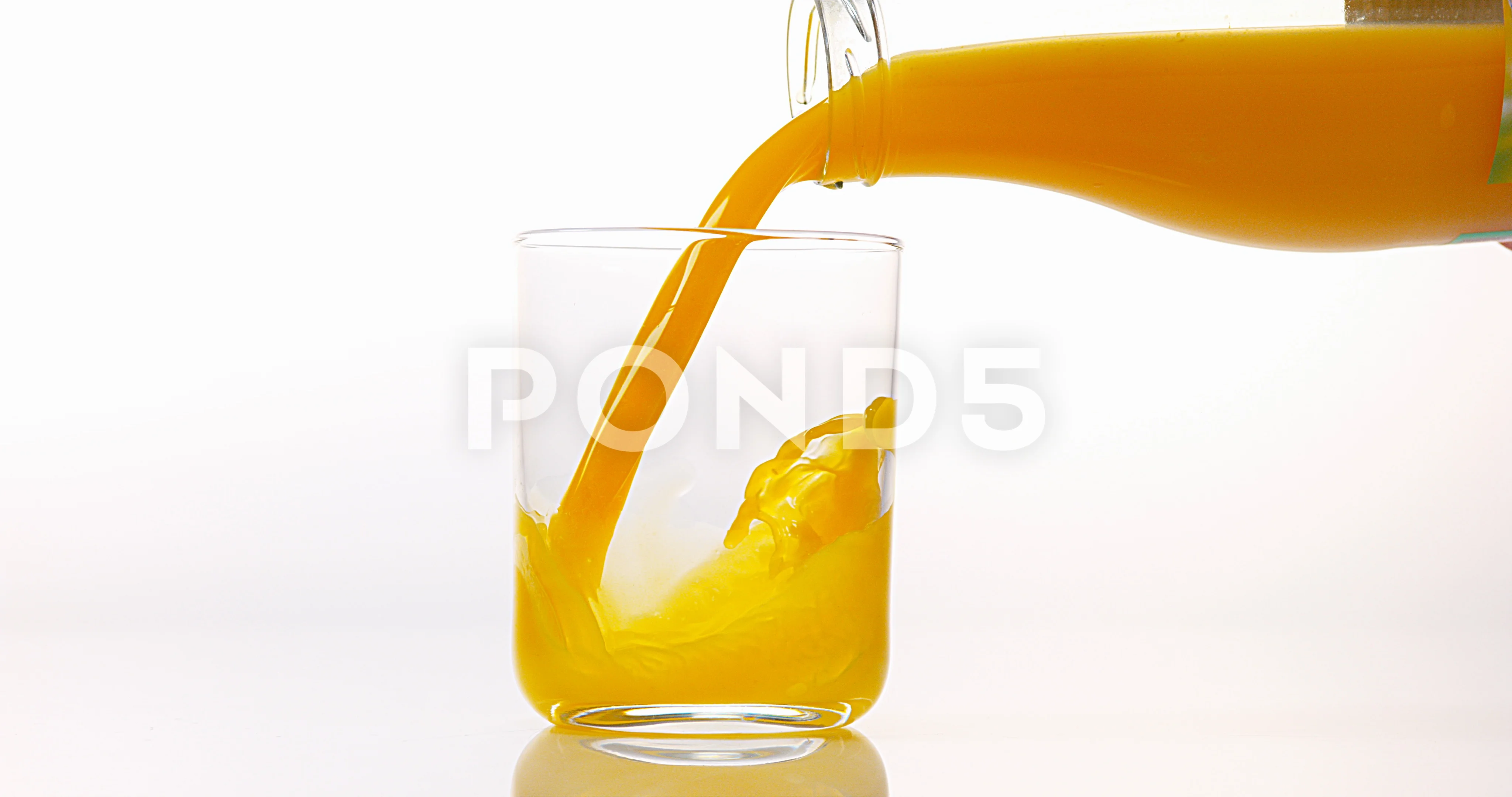 Pitcher filled with freshly-squeezed orange juice being poured into a clear  glass Stock Photo by wirestock