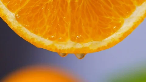 Orange juice dropping from orange slice in slow motion Stock Footage 113586077