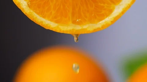 Orange juice dropping from orange slice in slow motion Stock Footage 113586340