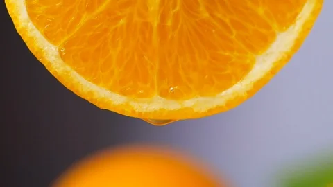 Orange juice dropping from orange slice in slow motion Stock Footage 114308265