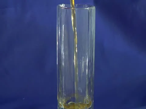 Orange juice flows in glass Stock Footage 22152064