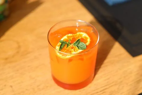 Orange juice with fresh mint leaf and dried orange slice served with ice Stock Photos