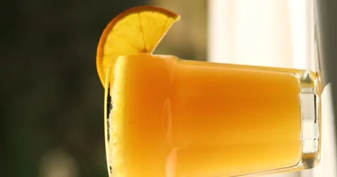 Orange juice in a glass on the window, close-up Stock Footage 246877249