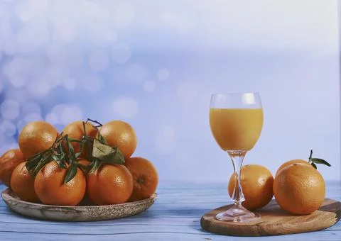 Orange juice with group of oranges Stock Photos