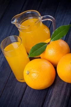 Orange juice in the jug on the table. rustic still life Stock Photos