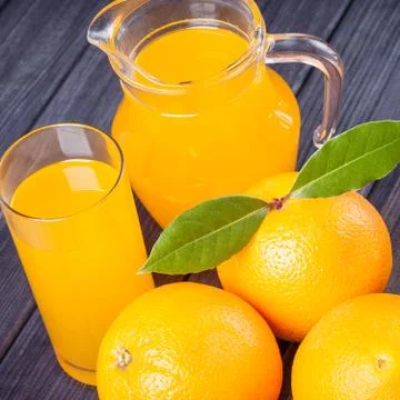 Orange juice in the jug on the table. rustic close up still life Stock Photos