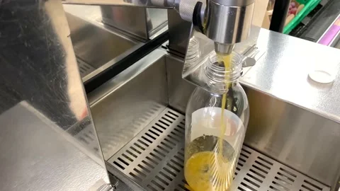 Orange Juice Machine Making Juice in Supermarket Stock Footage 167355519