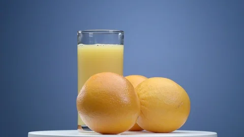 Orange juice with oranges on the rotating table Stock Footage 99363312