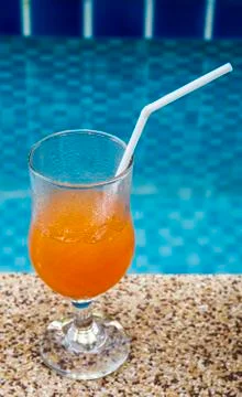 Orange juice at pool. Stock Photos