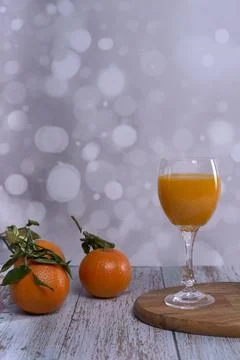 Orange juice with several oranges Stock Photos