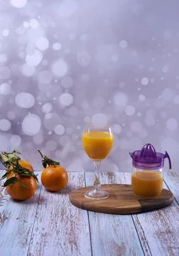 Orange juice with several oranges Stock Photos