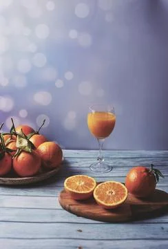 Orange juice with several oranges Stock Photos