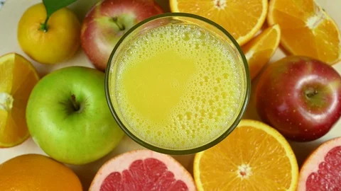 Orange juice spin on table Stock Footage 120401741