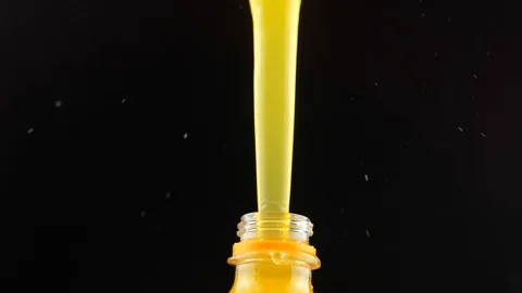 Orange juice splash out of bottle Stock Footage 110459896
