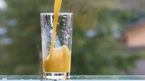 Orange juice on the table,on green background. Video stock 51689812