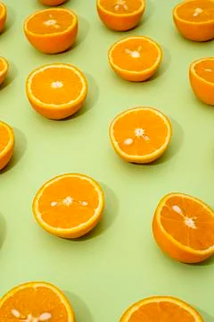 Orange juicy oranges split in half on green Stock Photos