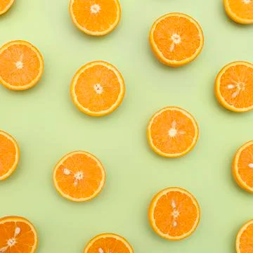 Orange juicy oranges split in half on green Stock Photos