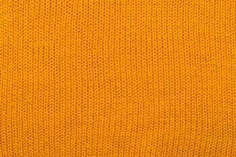 Orange knitted background Stock Photos