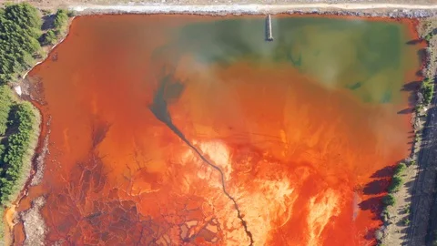 Orange lake. Ecological catastrophy. Stock Footage 129851593
