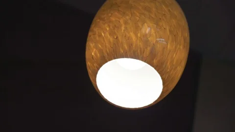 Orange lamp on the black ceiling Video stock 129737202