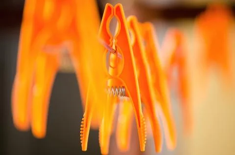 Orange laundry hooks on the wire Stock Photos