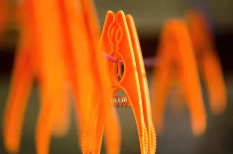 Orange laundry hooks on the wire Stock Photos