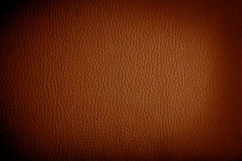 Orange leather background or texture with dark vignette borders Stock Photos