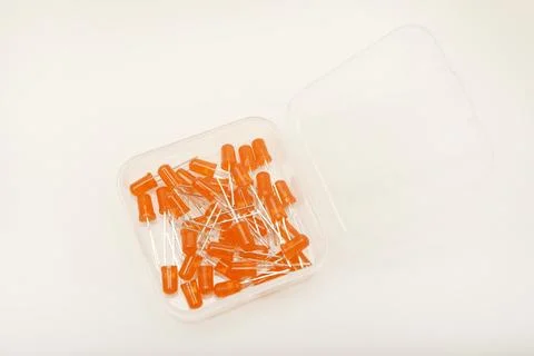 Orange LEDs in a plastic box. Semiconductor diodes. Electronic components. Stock Photos