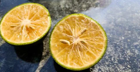 Orange lemon background. Double slice of lemon selective focus . Stock Photos