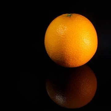 Orange lies on the table on a black background, fruit Stock-Fotos