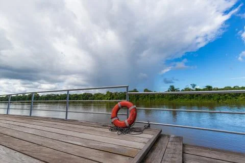 Orange Lifebuoy Ring With River Background Stock Photos