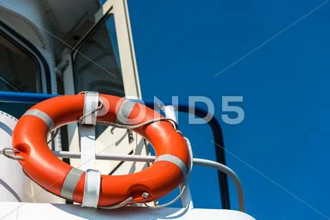 Orange lifebuoy on a white yacht Stock Photos